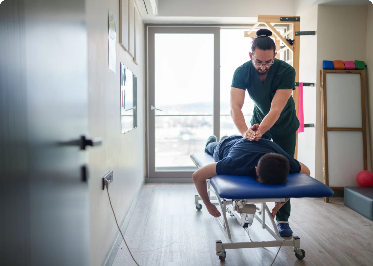 Chiropractor adjusting patient's back
