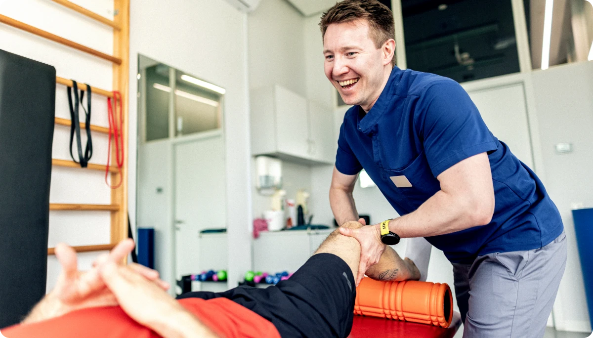 Therapist helping patient with leg movement